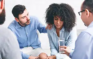 Woman taking Enclomiphene tablet as part of hormonal balance treatment